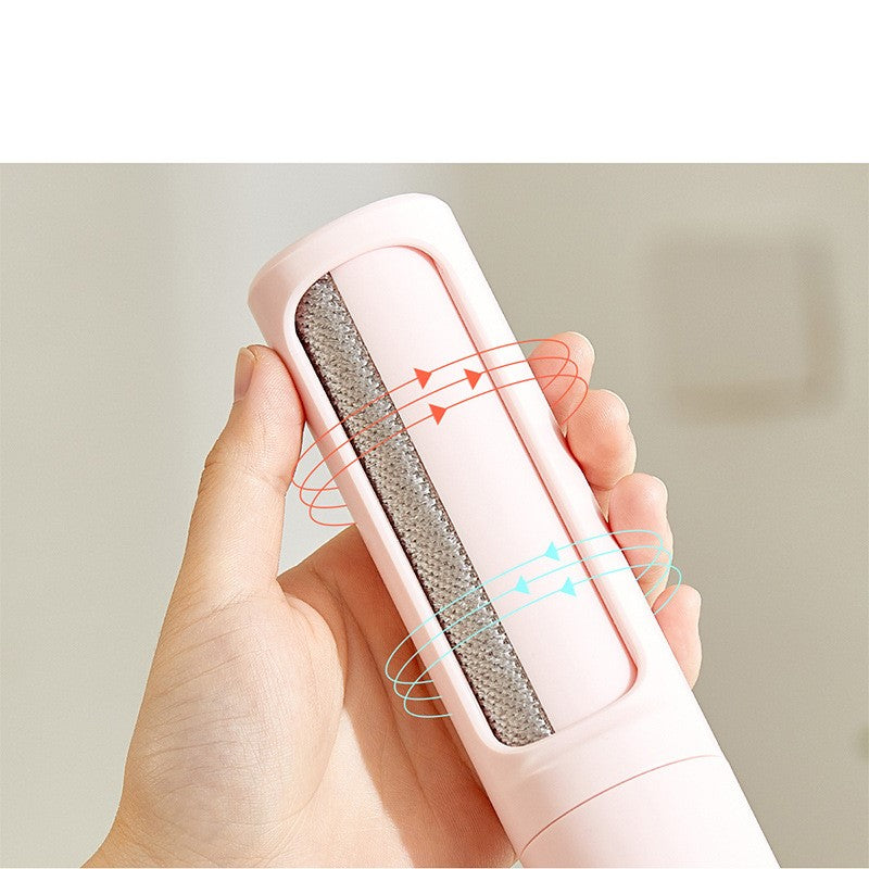 Reusable pet hair remover brush removing dog hair from a fabric couch